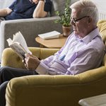 An older man reading a newspaper