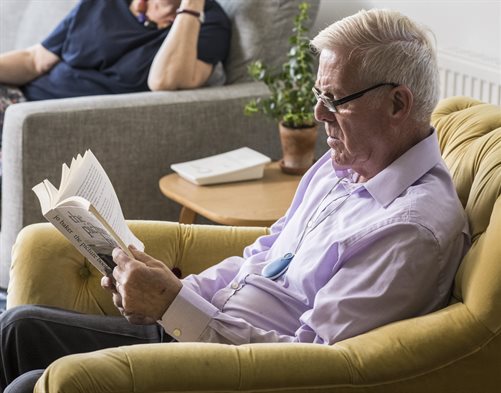 Man in chair wearing pendant