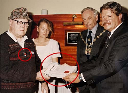 Careline customer posing with Careline team members and Councillor with equipment in 1990's
