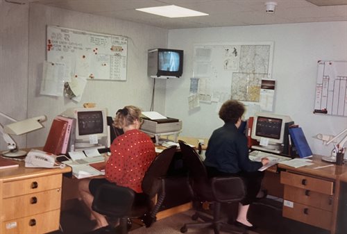 The Careline control room in 1992 with two call operators working on their desks at computers.