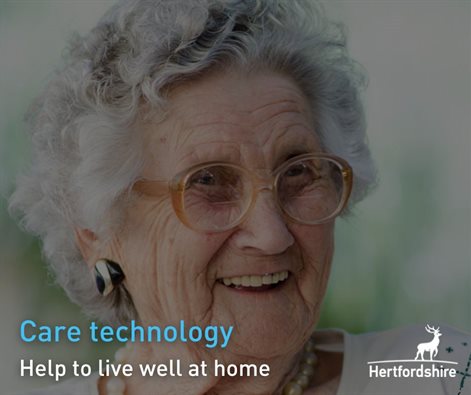Elderly lady smiling with Hertfordshire County Council logo in corner