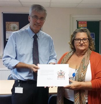 A member of the Herts Careline team receiving a long service award.